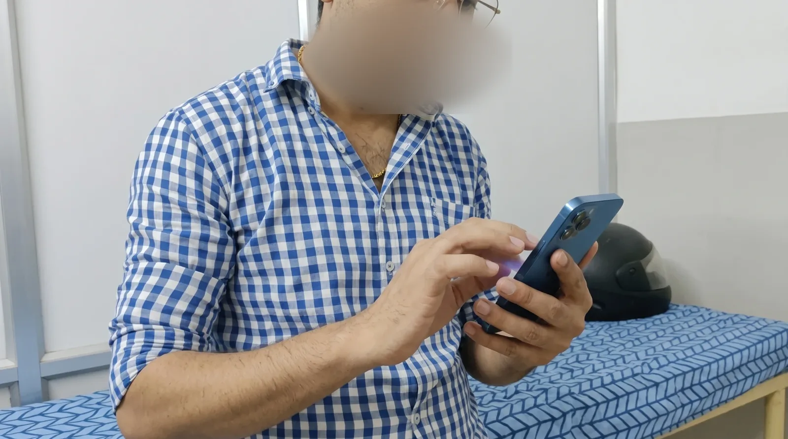 A doctor tapping a phone to try a task, face blurred